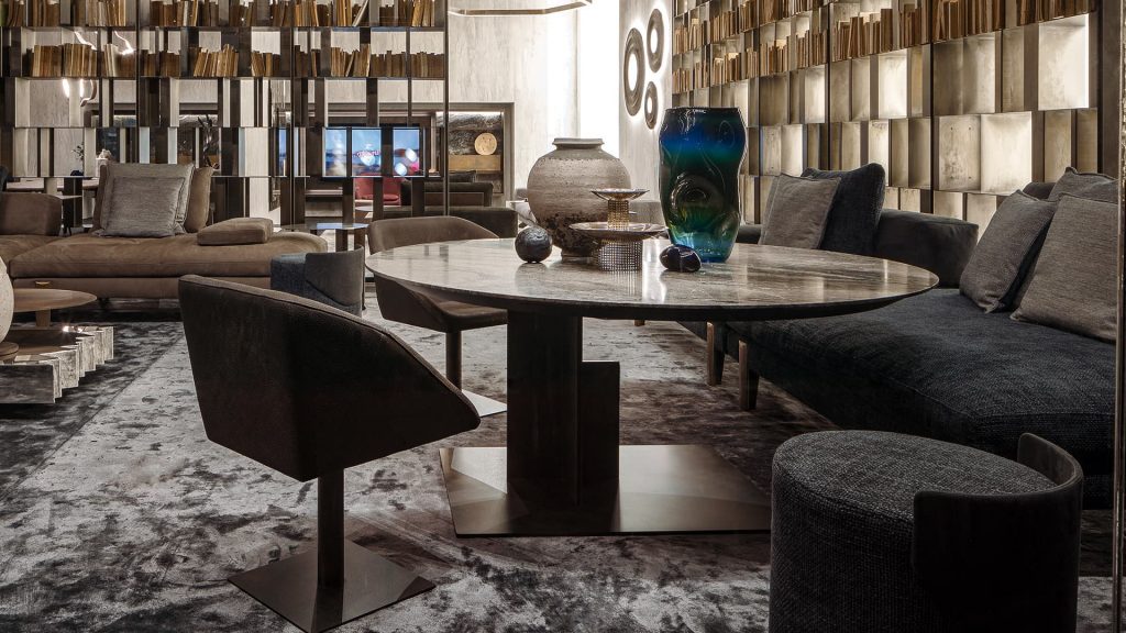 Round Shift Table Lounge. Central leg burnished black steel, top in gray and black marble in a dining room.