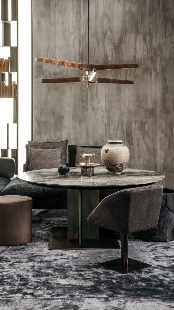 Round Shift Table Lounge. Central leg burnished black steel, top in gray and black marble in a dining room.