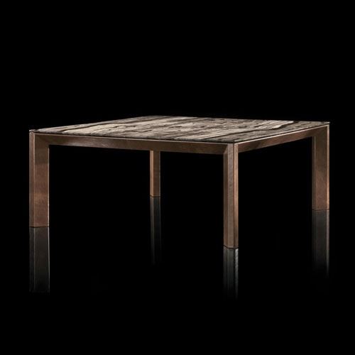 Soprano dining table, structure and four legs in brown wood, top in white, grey, brown and black stone on a black background.
