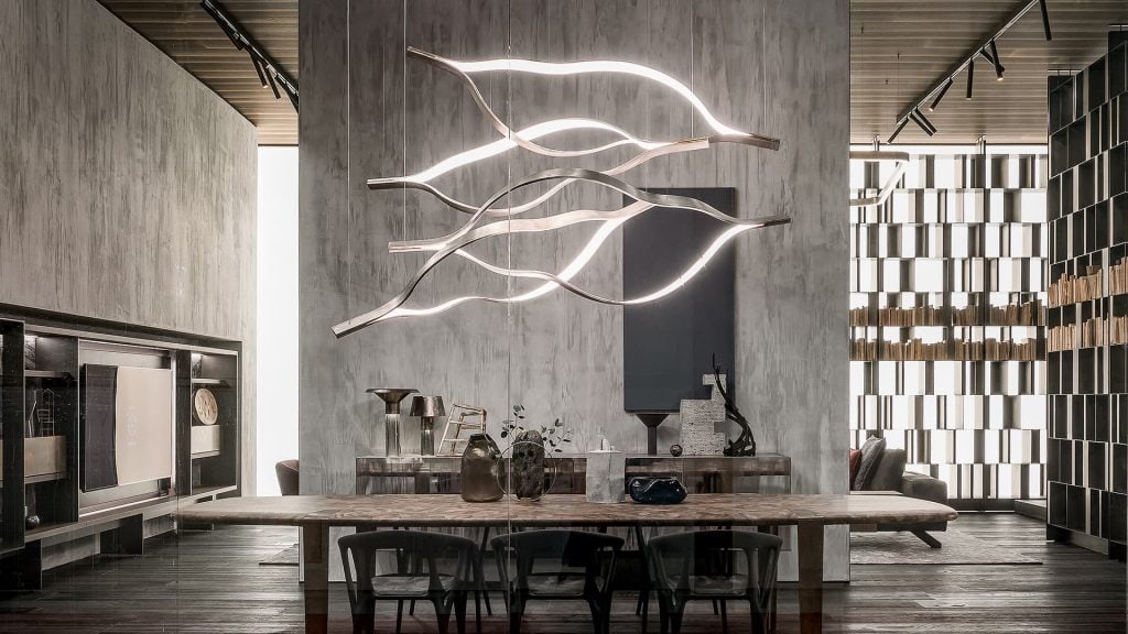 Four led Tape Light with wave shapes creating a dune like pattern using suspension cables. White light and silver structure color in a dining room.