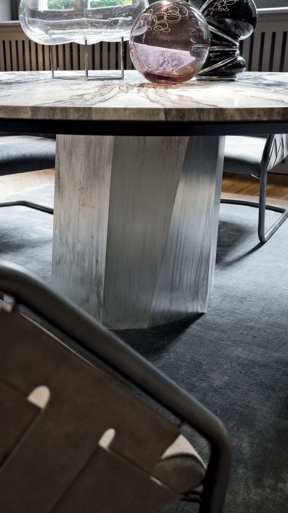 Zenith Table leg in silver brass casing in a dining room.