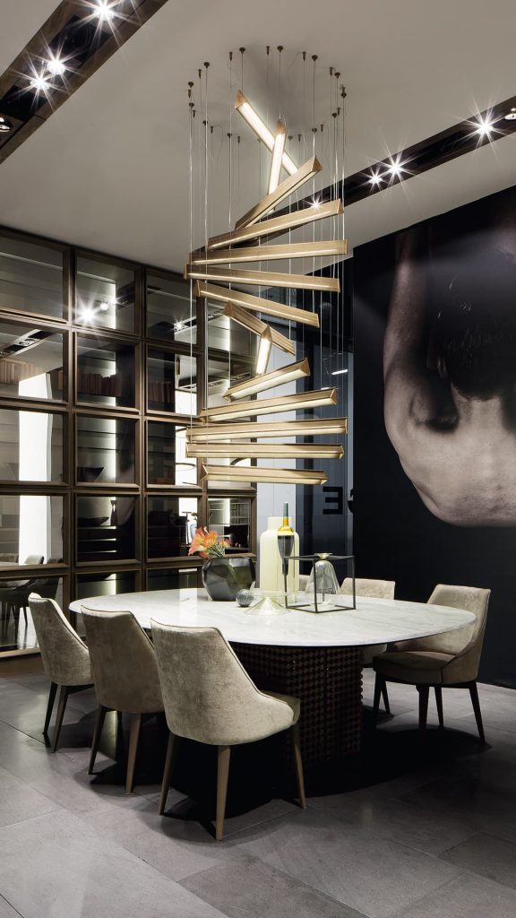 Seven Y Lights of y shaped body with steel suspension cables. Finish structure in brass in a dining room.