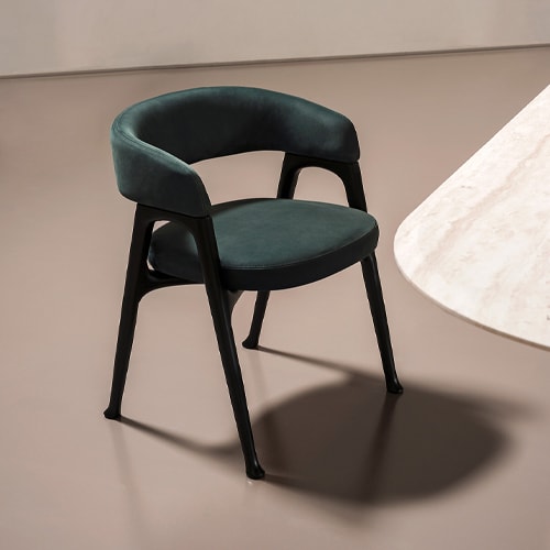 Black wooden structure chair with foam padding upholstered in green acrylic fiber in a room