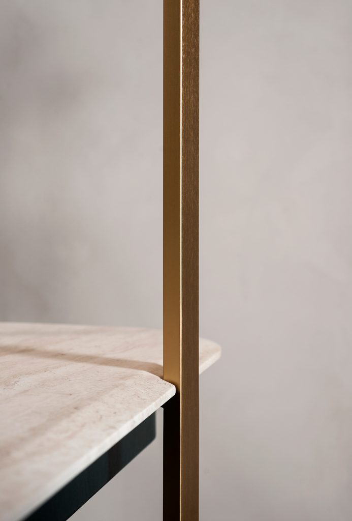 desk in beige and black with one of the bases in golden brass aluminum