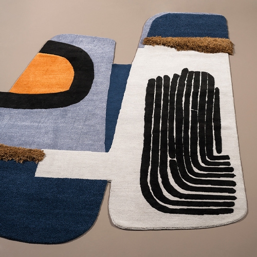 Rug with unique design in white, blue, black and brown colors.