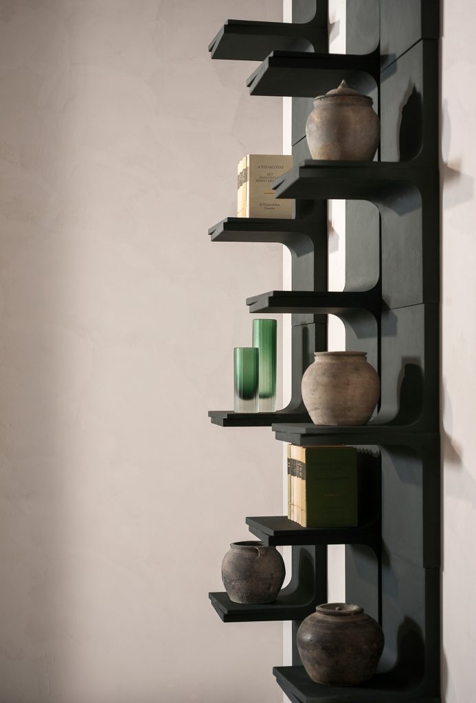 matte black color shelf with various decorative shelves a beige backgorund.