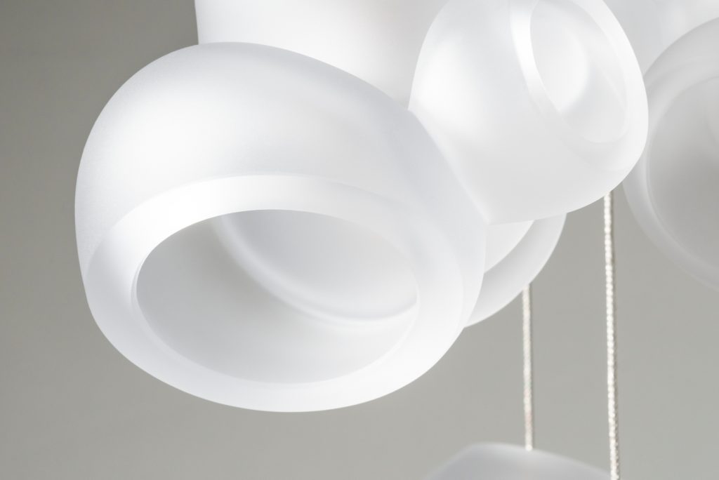 circular white lamp sculpture on a white background
