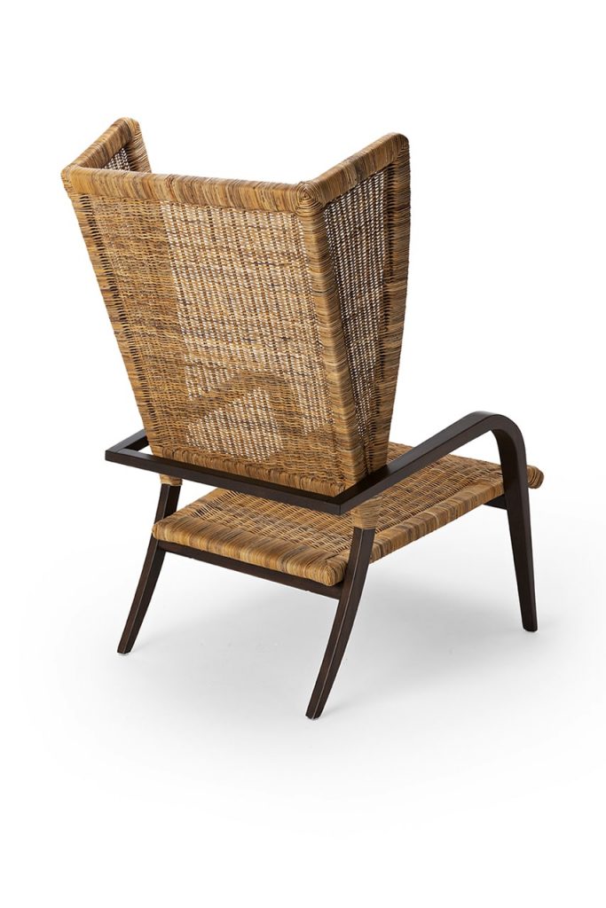 woven chair with large floating backrest on a white background.
