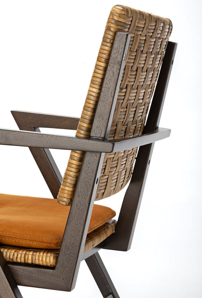 chair with orange hand-woven backrest on a white background.