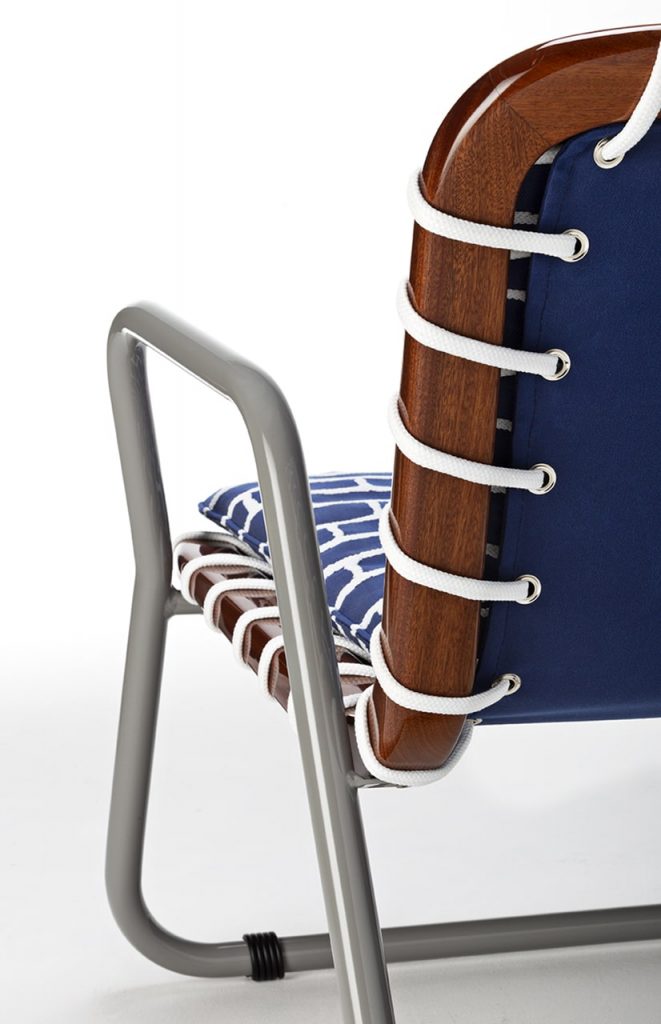 chair made with blue and ivory rope intricately woven into brown wood, balanced on an aluminum base.