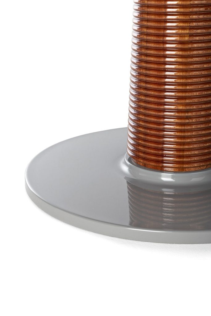 round brass and shiny wood table on a white background