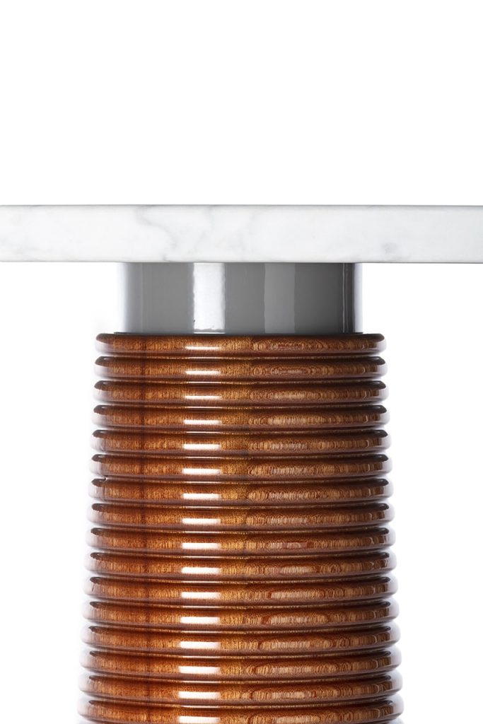 wooden table with gray brass base on a white background