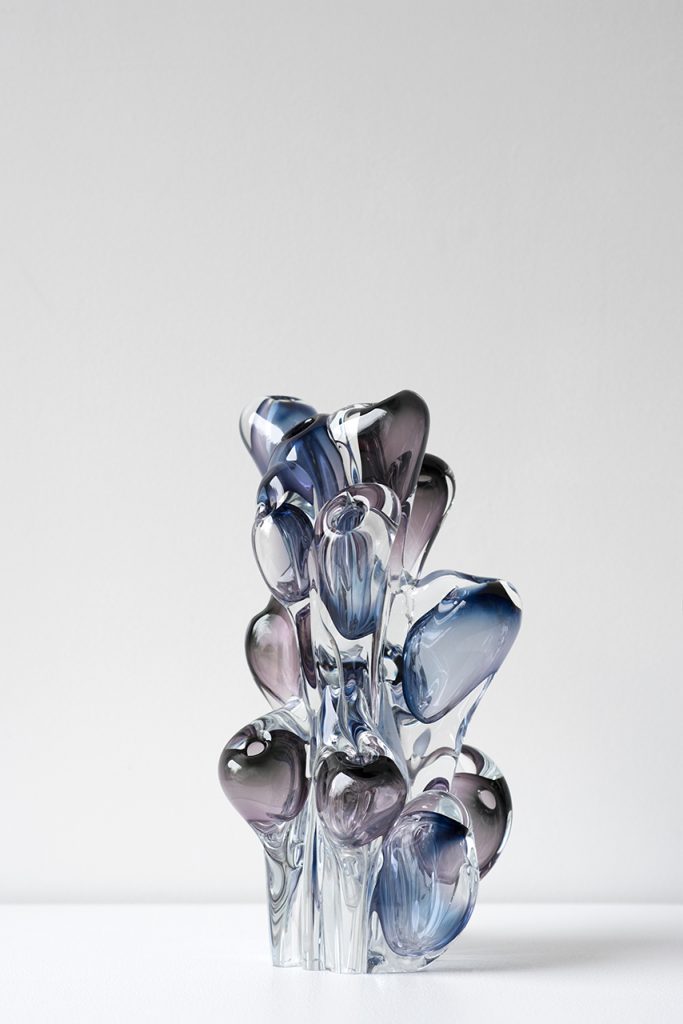 blue sculpture made of organic glass on a white background.