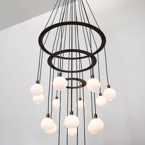 The transparent black Drape chandelier hanging from the ceiling.
