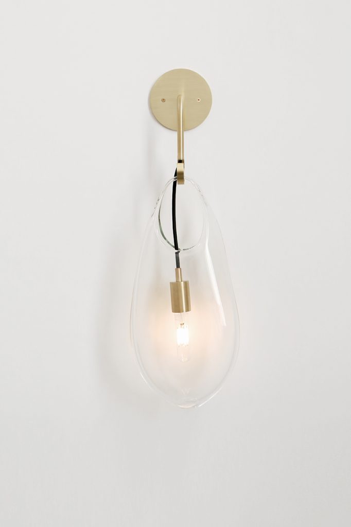 golden glass vessel hanging from the ceiling on a white background