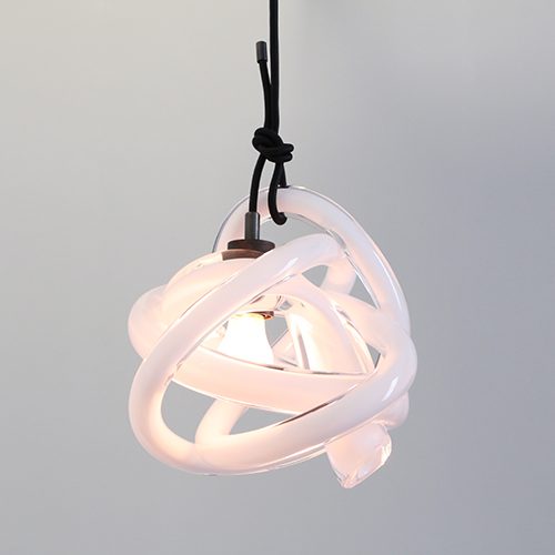 kLO Large Wrap: A pendant crafted from handblown glass tube a gray background.