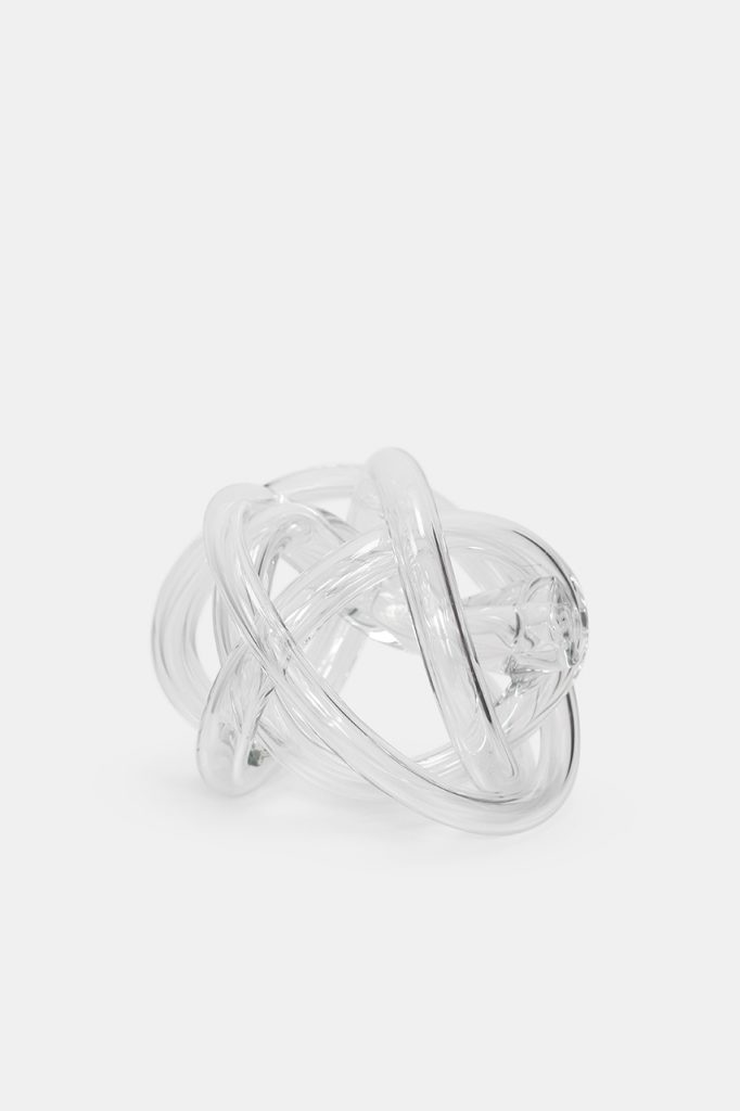 Clear hand blown glass tube with a braided design on a white background.