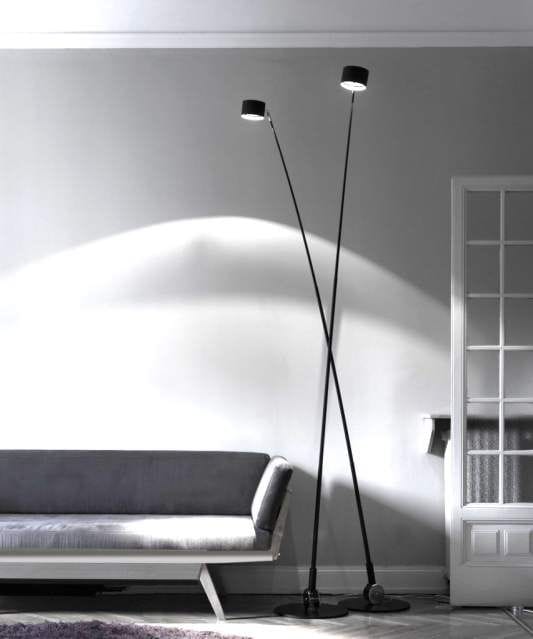 Height-adjustable floor lamp with matte black metal structure on a star room.