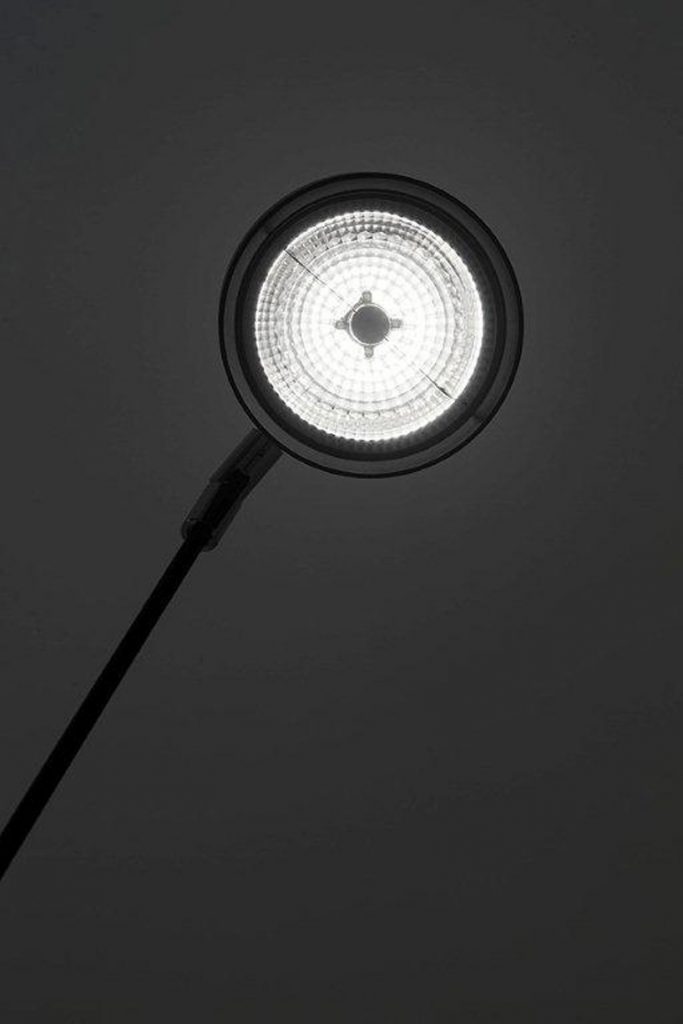 Telescopic floor lamp in matte black that provides warm 2700K lighting on a white background.