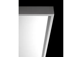 Generously sized mirror supported by sturdy aluminum structure a black background.