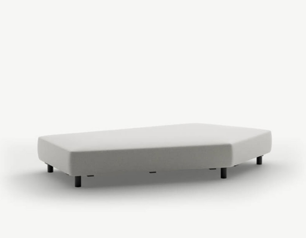 A light grey outdoor sofa base with a pentagonal silhouette, resting on short cylindrical black legs for a grounded, contemporary appeal.