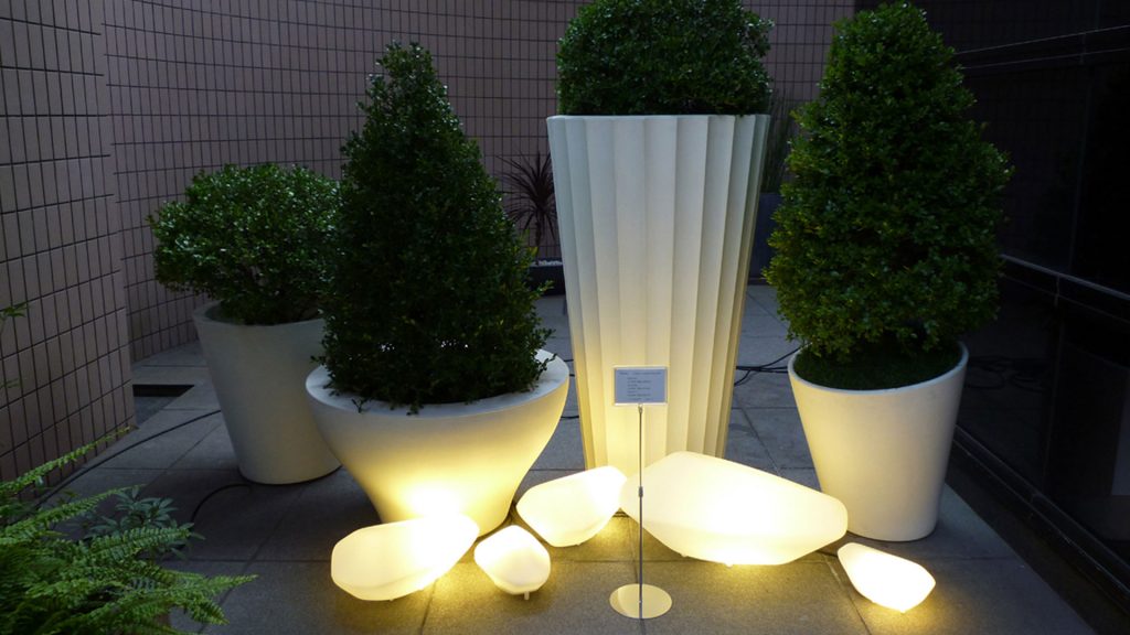 line of lamps made of stones of different sizes made of glass in a yellow tone