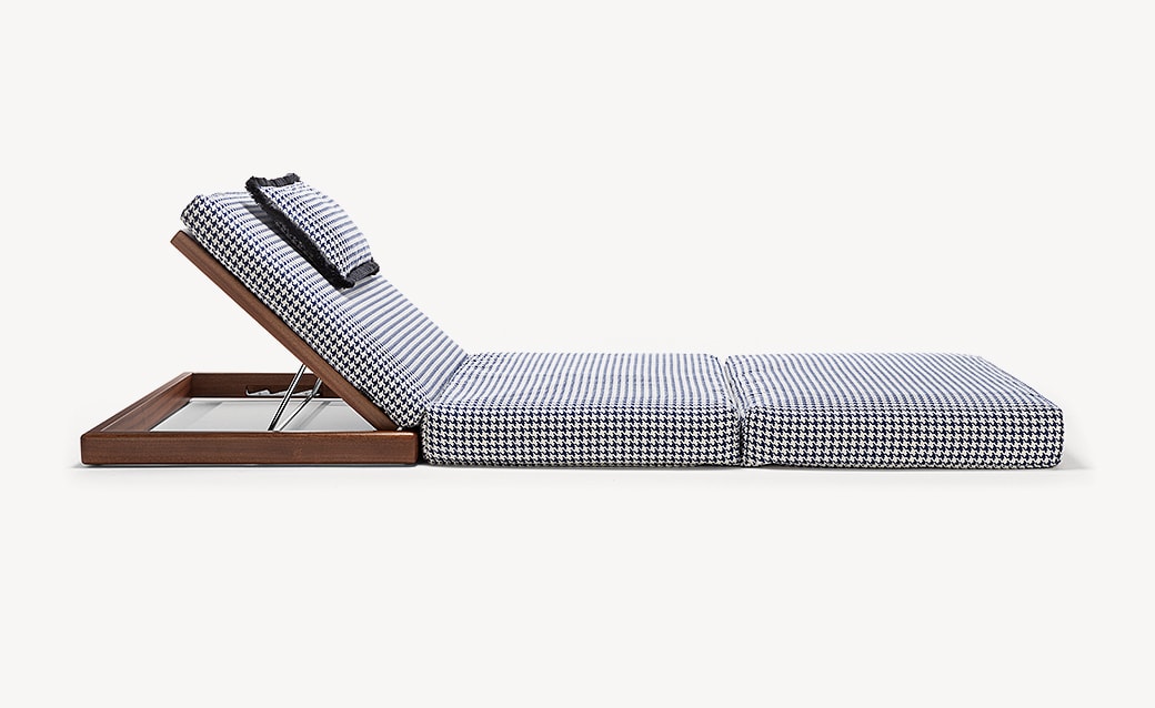 Poolside Bed with a wooden frame and light gray cushioned upholstery