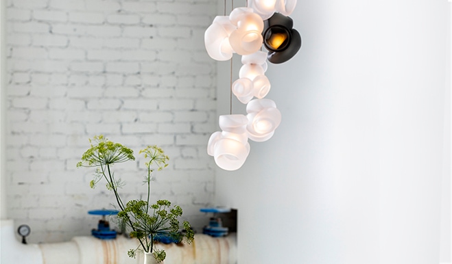 Bocci sculptural wall light installation featuring a cascade of delicate glass orbs in varying translucency