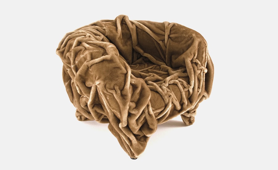 Ginza armchair with a unique, crumpled fabric design in a warm brown tone, creating a plush and sculptural seating experience