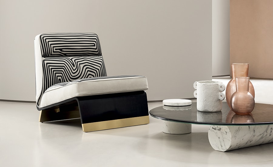 Greta Special Edition lounge chair with a sleek black and gold base, paired with a zebra-patterned cushion for a bold contemporary look
