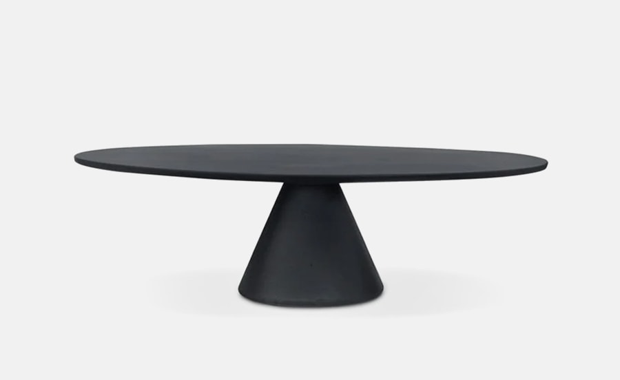 The Jove Low Table features a minimalist, modern design with a sleek black finish, a smooth round tabletop, and a sturdy conical base for a bold, sculptural look