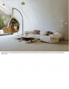 A minimalist living space with a curved, dome-like ceiling, featuring a neutral-toned sofa, a round coffee table, and a large arched window with a hanging chair
