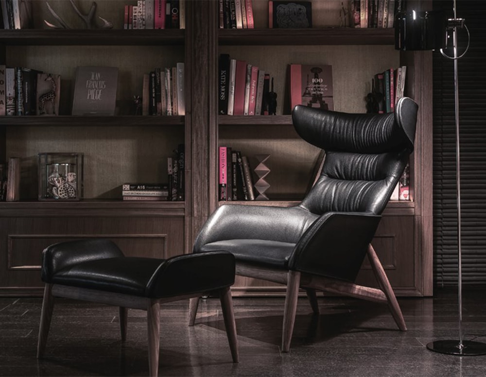 Armchair made of black leather with brown wooden base