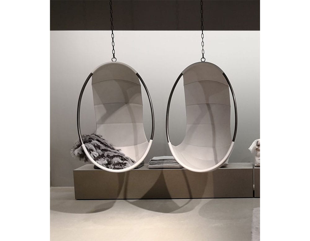 egg-shaped armchairs in cuddly covers and upholstered in gray leather