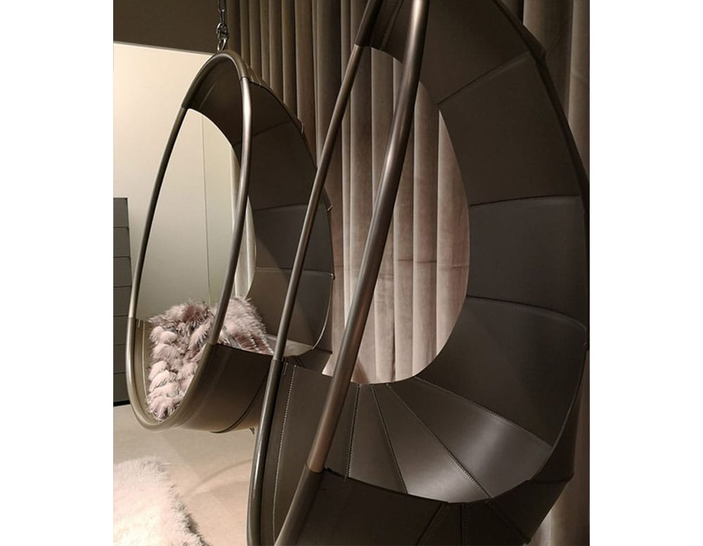 cocoon-shaped armchairs made from mimoso and upholstered in dark brown leather