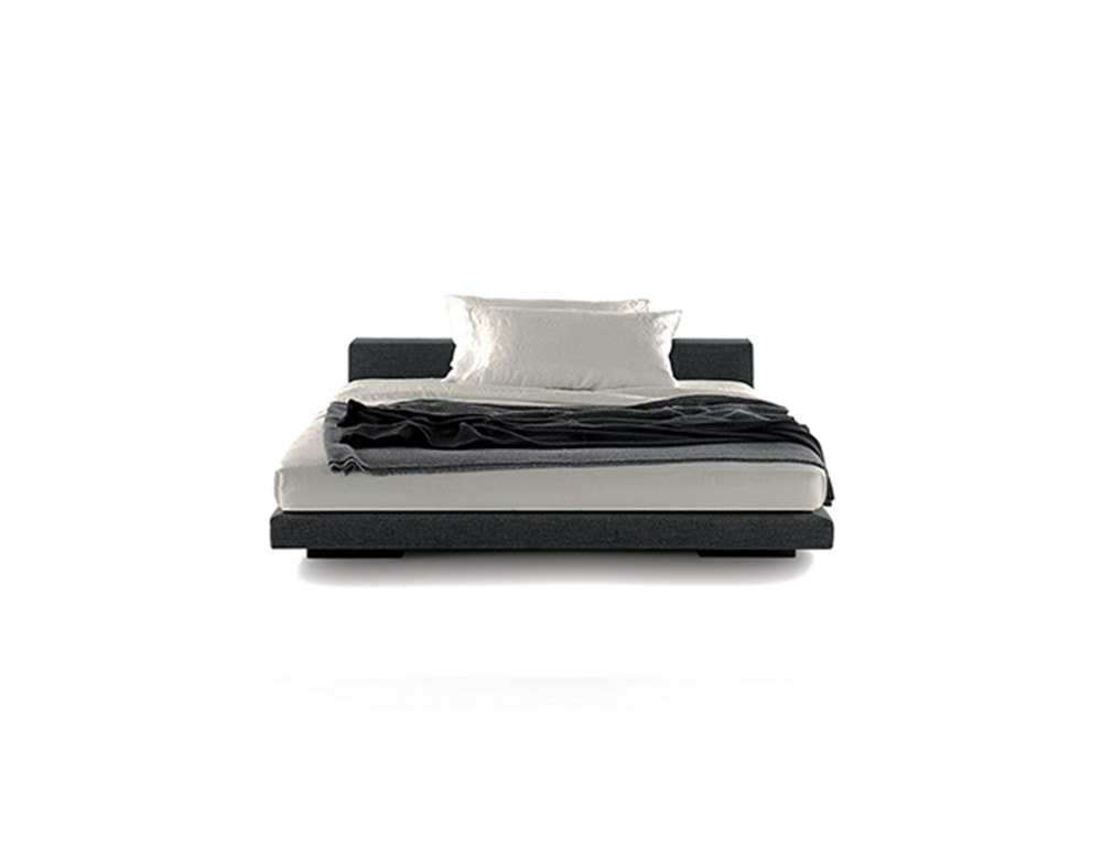 bed made of brass and upholstered throughout its structure with gray and black leather