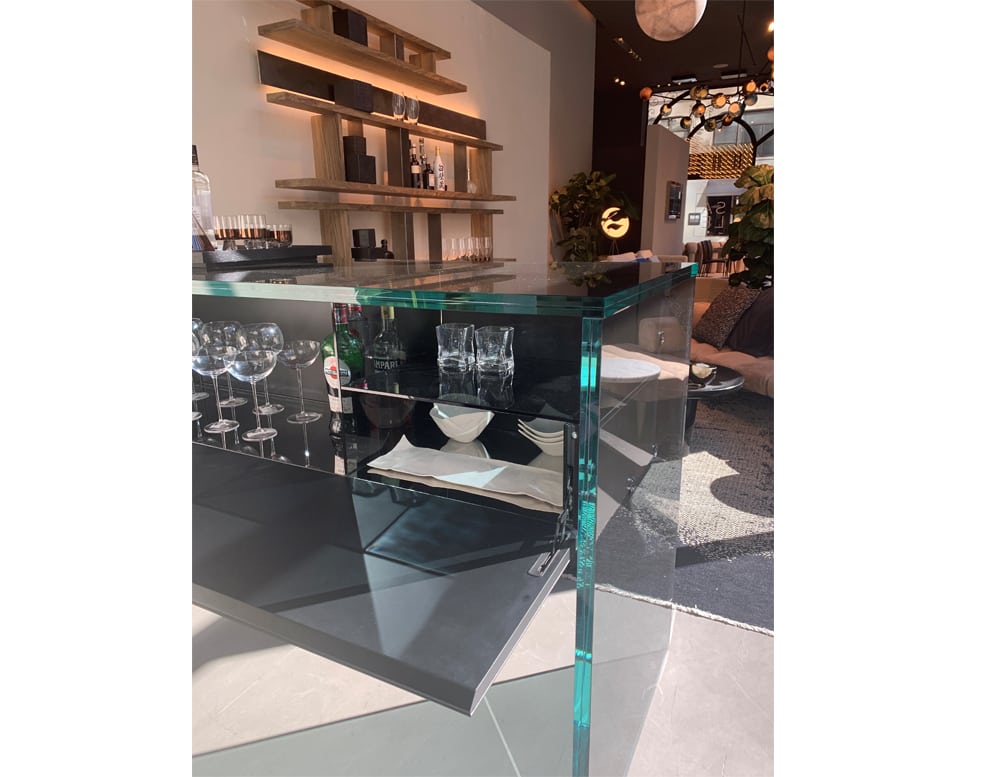 bar made of extra clear glass with black wooden base and several cabinets in a background room