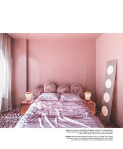 Soft pink bedroom featuring a cozy bed, modern nightstands with warm lighting, and a unique circular mirror leaning against the wall.