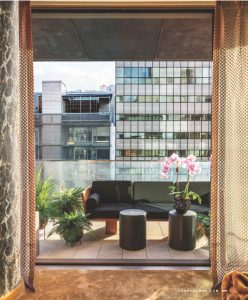This image showcases a beautifully framed view of an outdoor seating area with plants, contemporary furniture, and a modern architectural backdrop. Let me know if you need any descriptions, edits, or more details!
