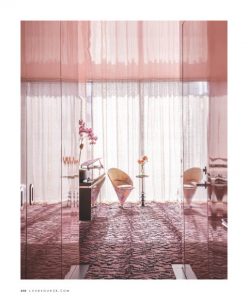 A dreamy pink-toned lounge with sheer curtains, plush seating, and elegant decor, creating a soft and inviting atmosphere.