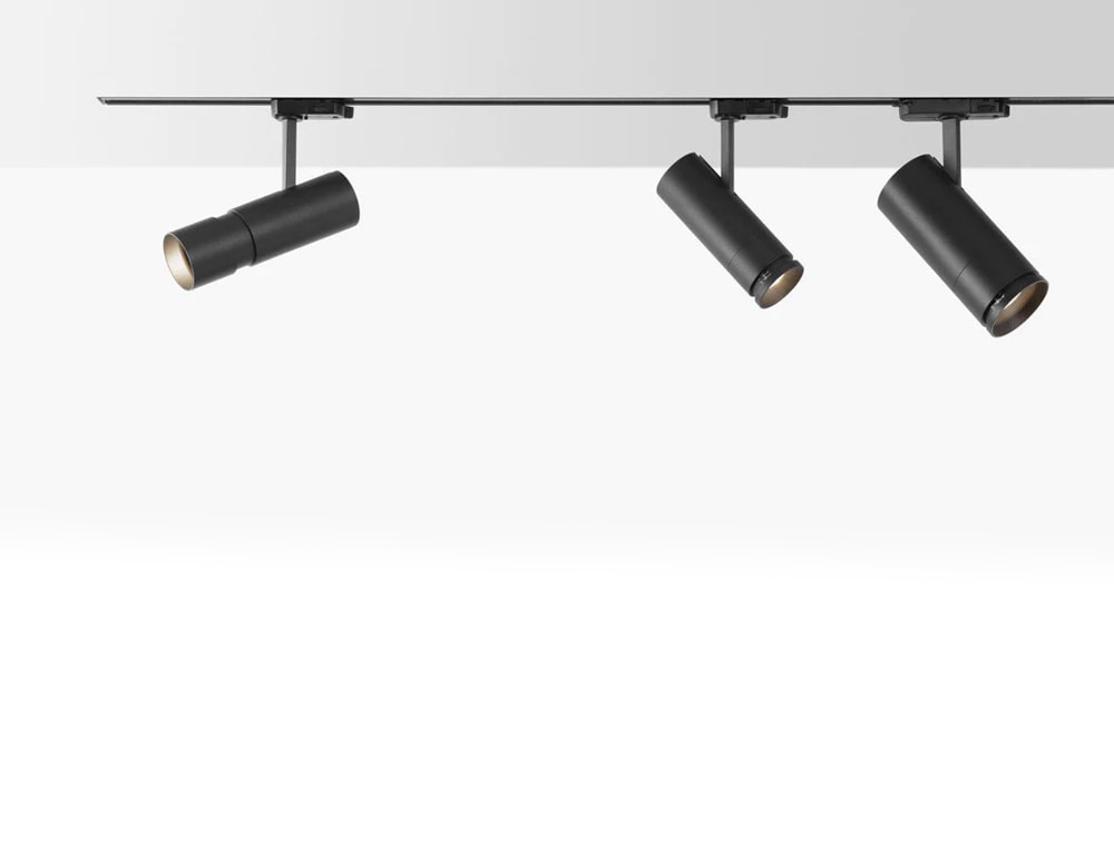 line of lamp spotlights made of black metal with LED lighting on a white background