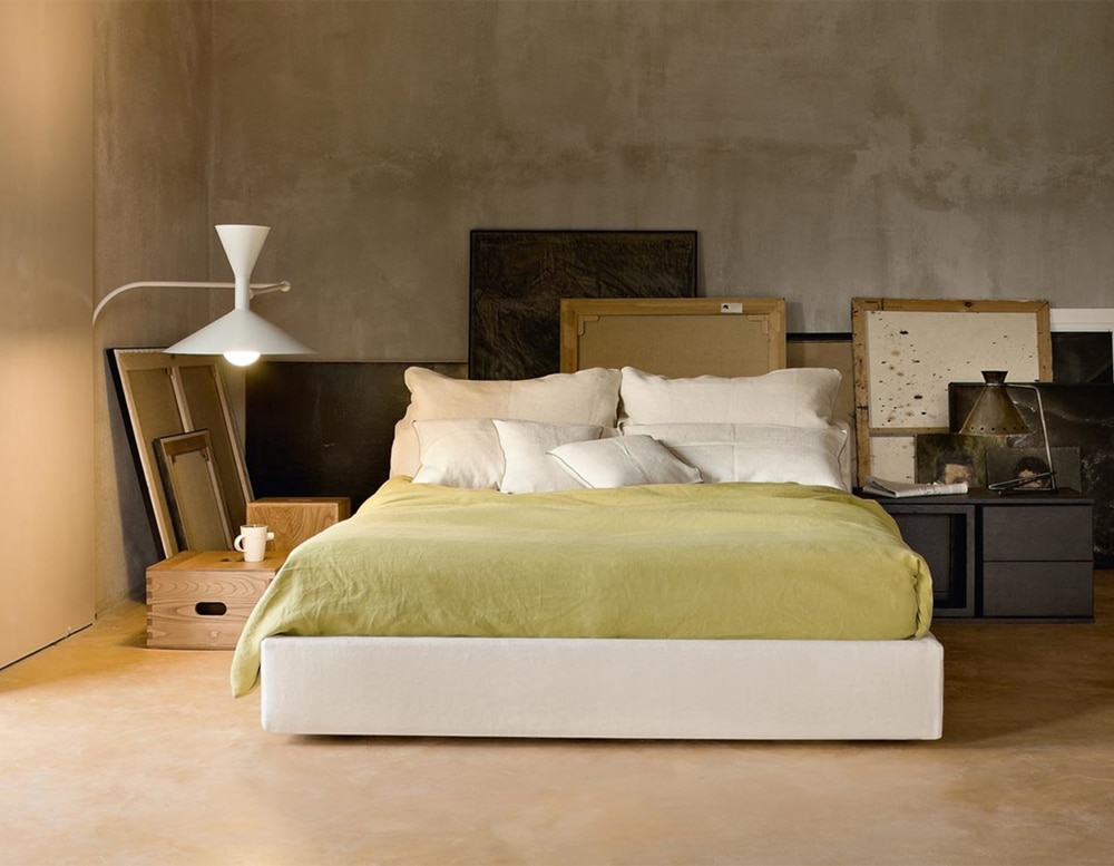 white metal lamp with a modifiable and striable elbow-shaped base in a room