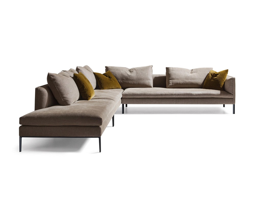 L-shaped sofa made of light brown textiles and lacquered metal legs in a white background