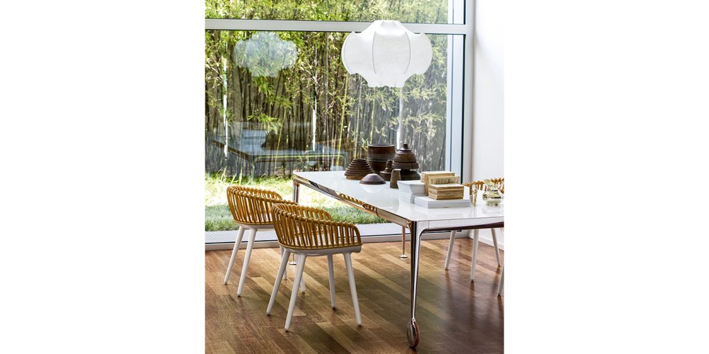 White dining chairs with openings in the back made entirely of polycarbonate