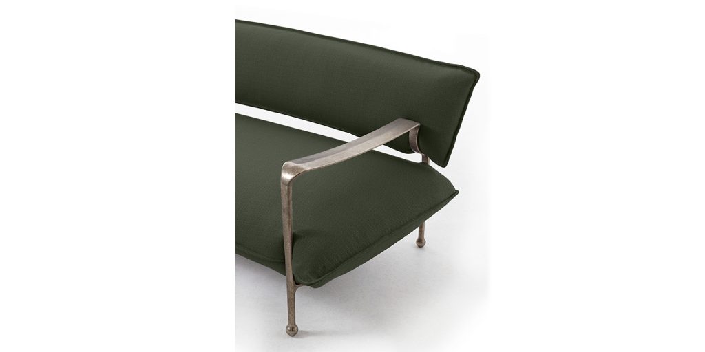 sofa made of bronze and upholstered with olive green fabric in a white background