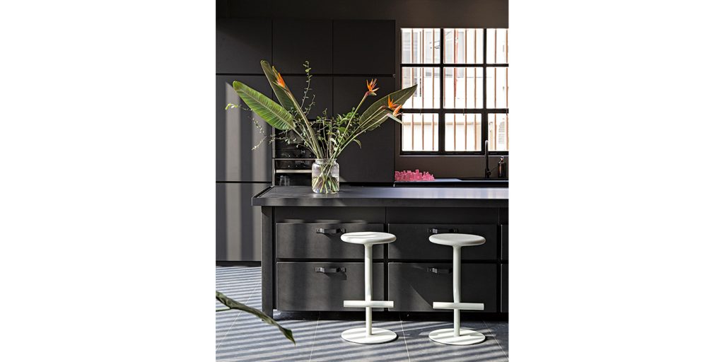 swives and adjustable bar stool in a white tone made of steel