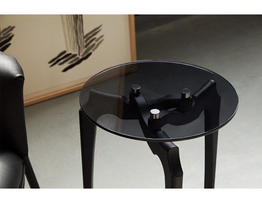 centerpiece made of black wood and circular glass lid in a living room