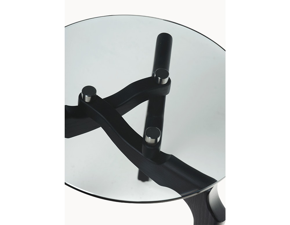 side table made of wood and glass top with circular shape in black tone on a white background centerpiece made of black wood and circular glass lid side table made with a transparent circular glass top on a white background