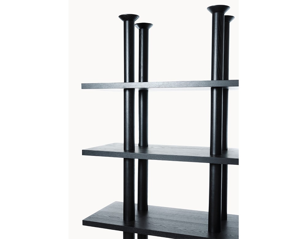 Shelf made of black wood with several levels of shelves and 4 cylinder-shaped bases