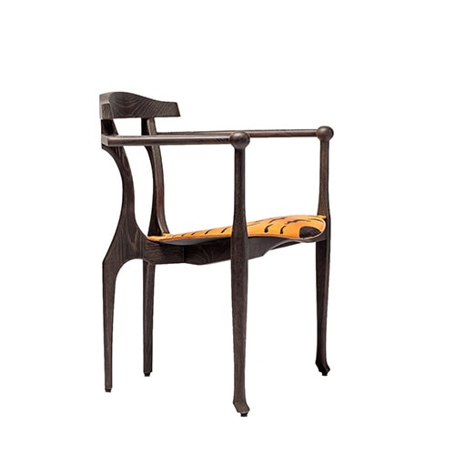 dining chair made from brown wood and upholstered in leather with tiger finishes